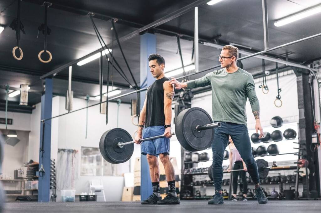 a man with a coach in gym