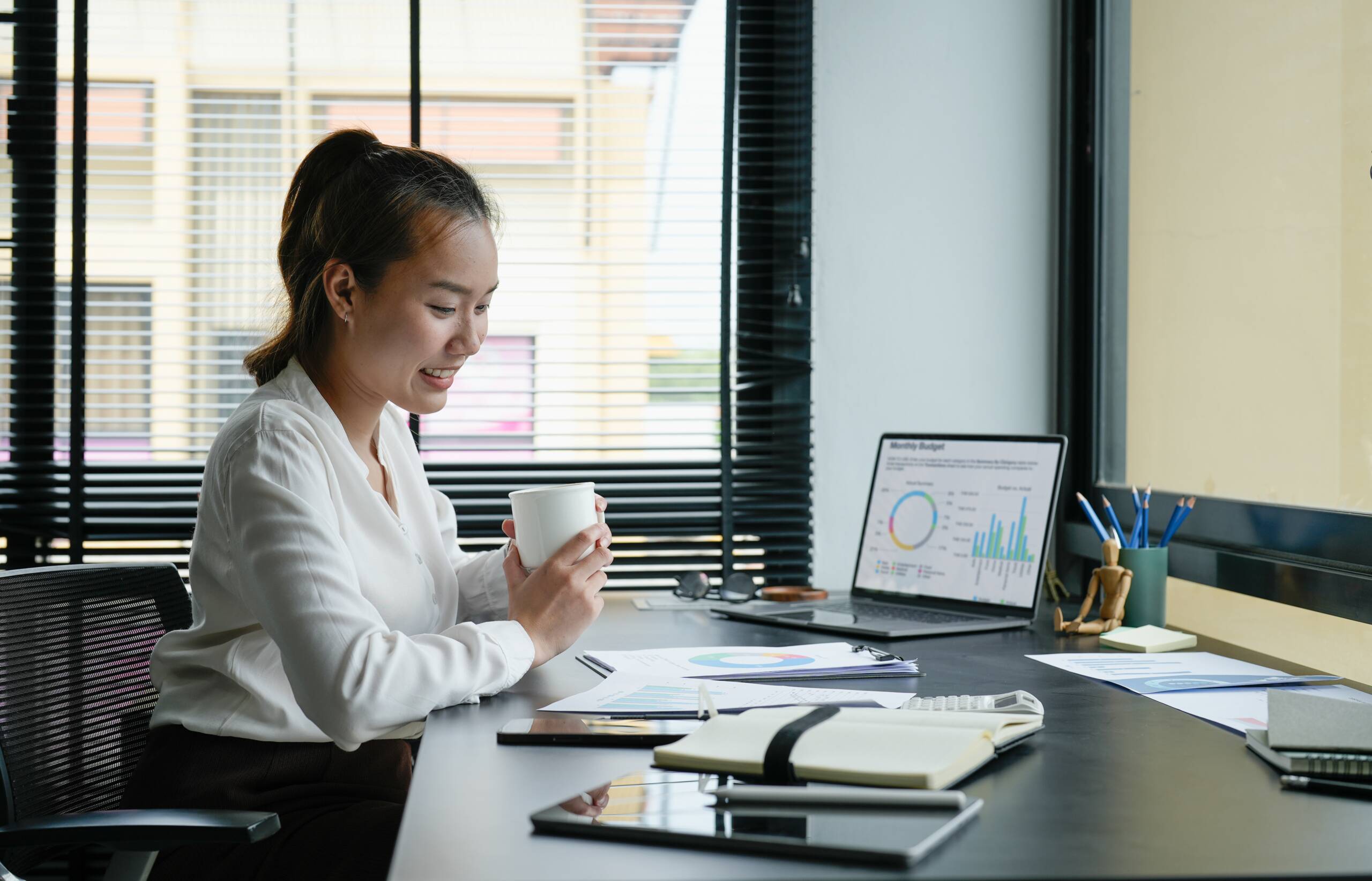 Business accountant asian woman analysis financial report at her office.