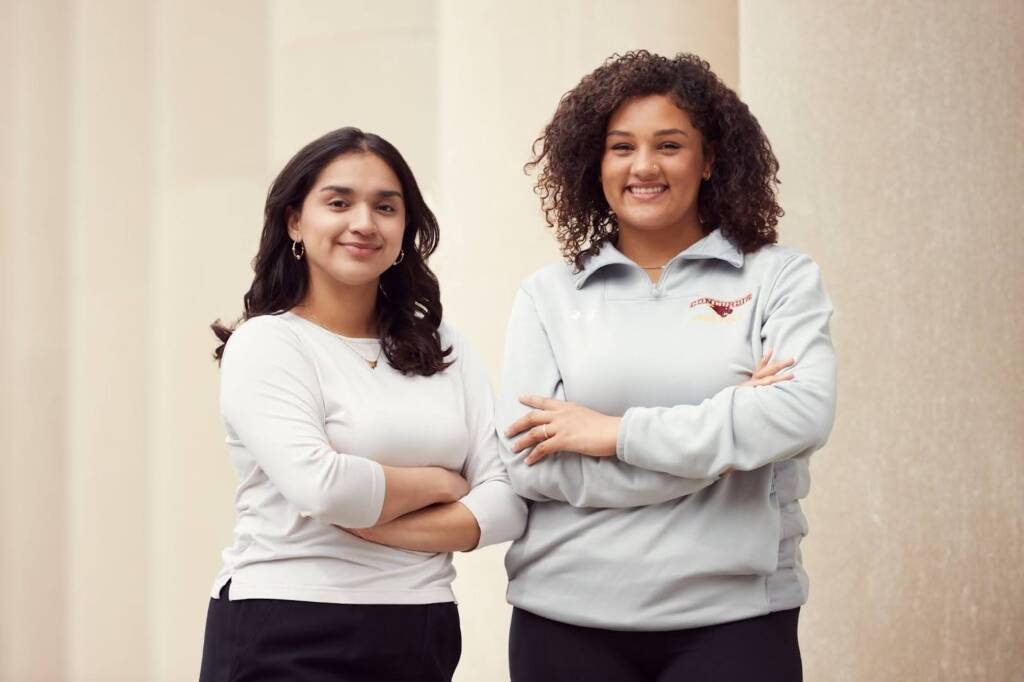 two students smiling at camera