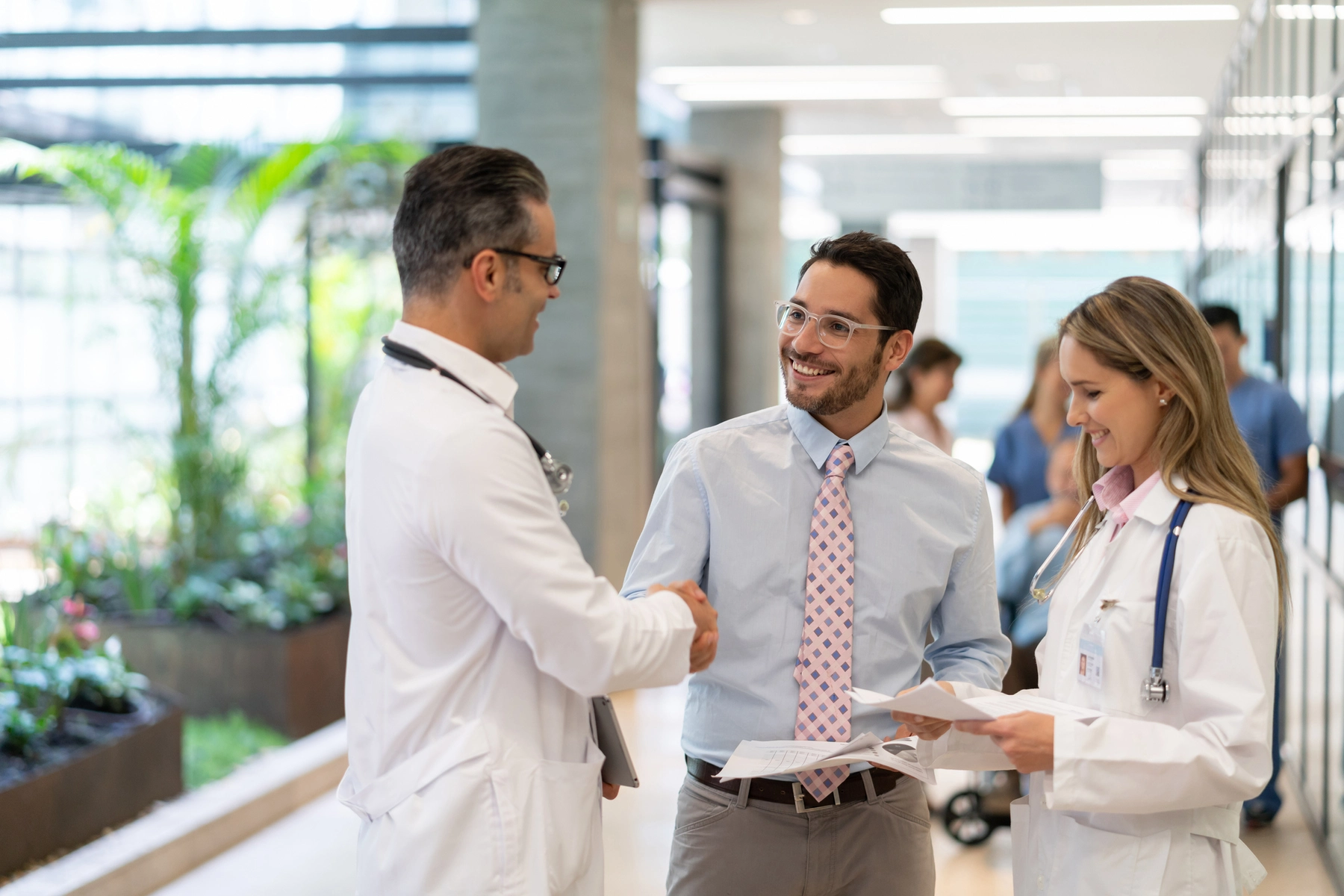 PhD graduate in exercise science shaking hands with employer in a clinical or academic setting