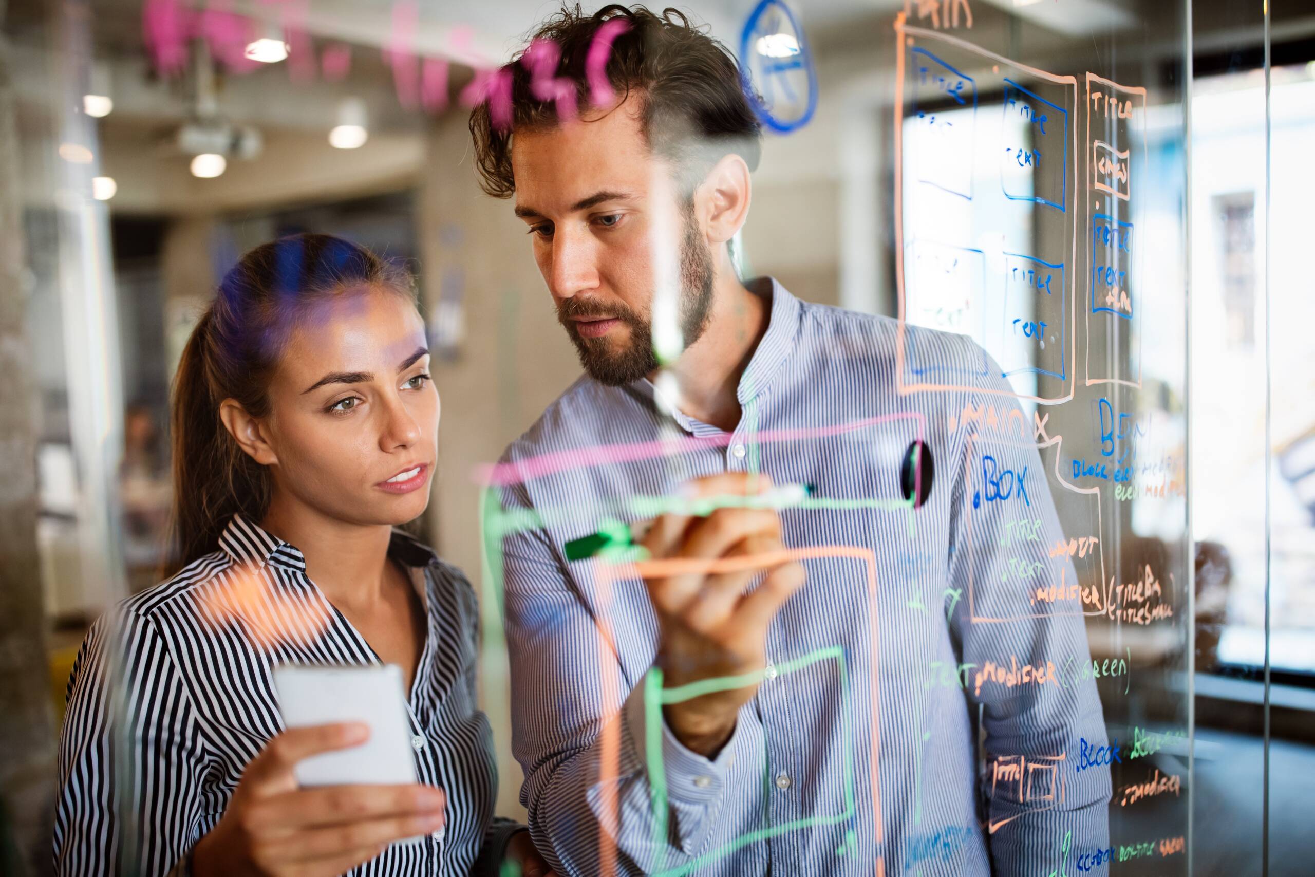 Industry professionals collaborating on complex concepts, symbolizing the transition from professional expertise to academic teaching and research.