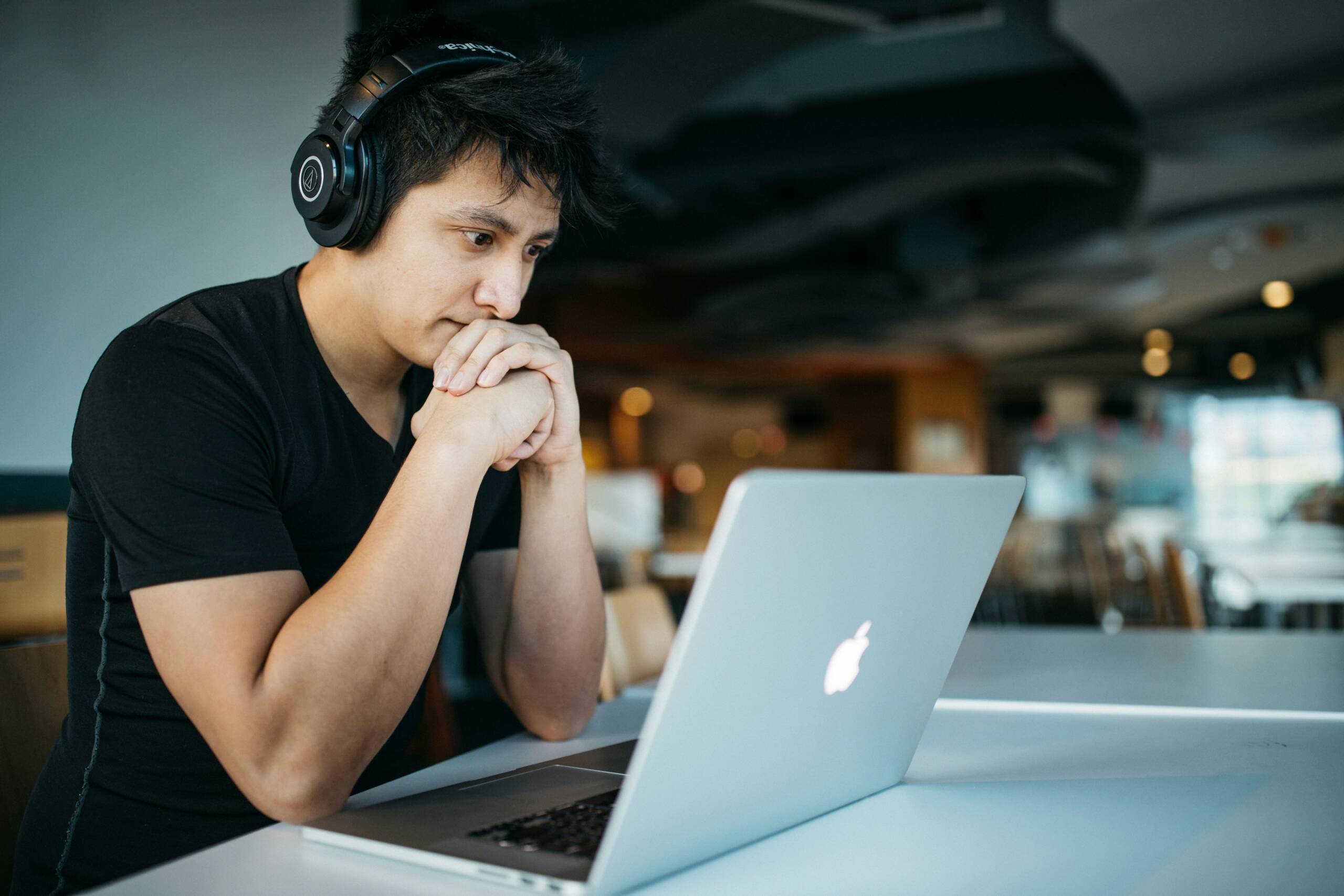 Student comparing online college programs while researching on a laptop at home