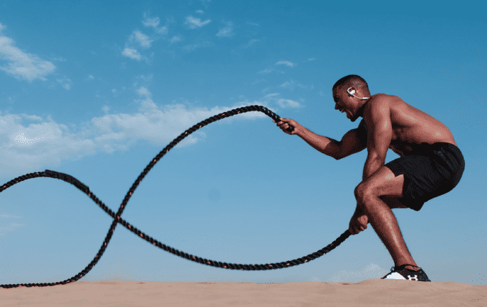 image of male using battle ropes