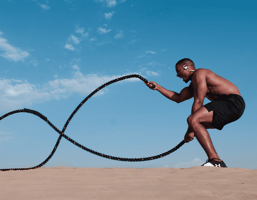 image of male using battle ropes