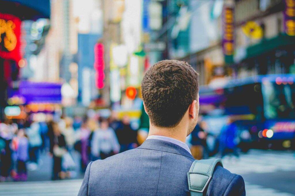 man walking in a downtown area