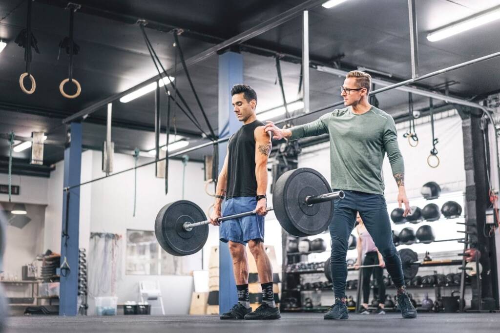 a man with a coach in gym a man with a coach in gym