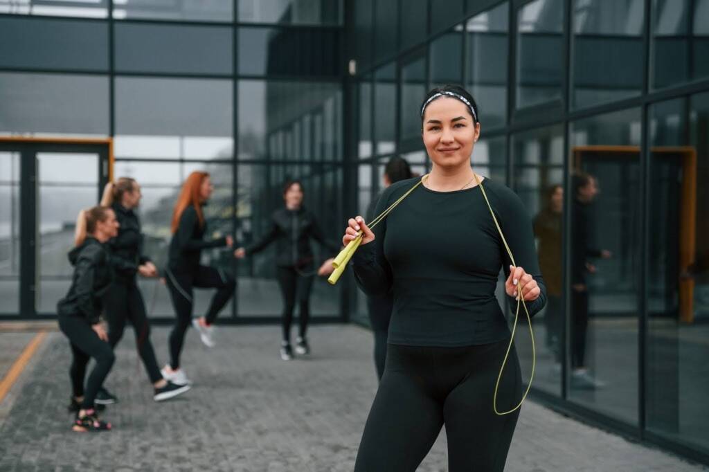 A woman holding exercise gear A woman holding exercise gear