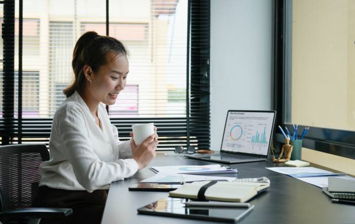 Professional reviewing salary trends and career data on a laptop.