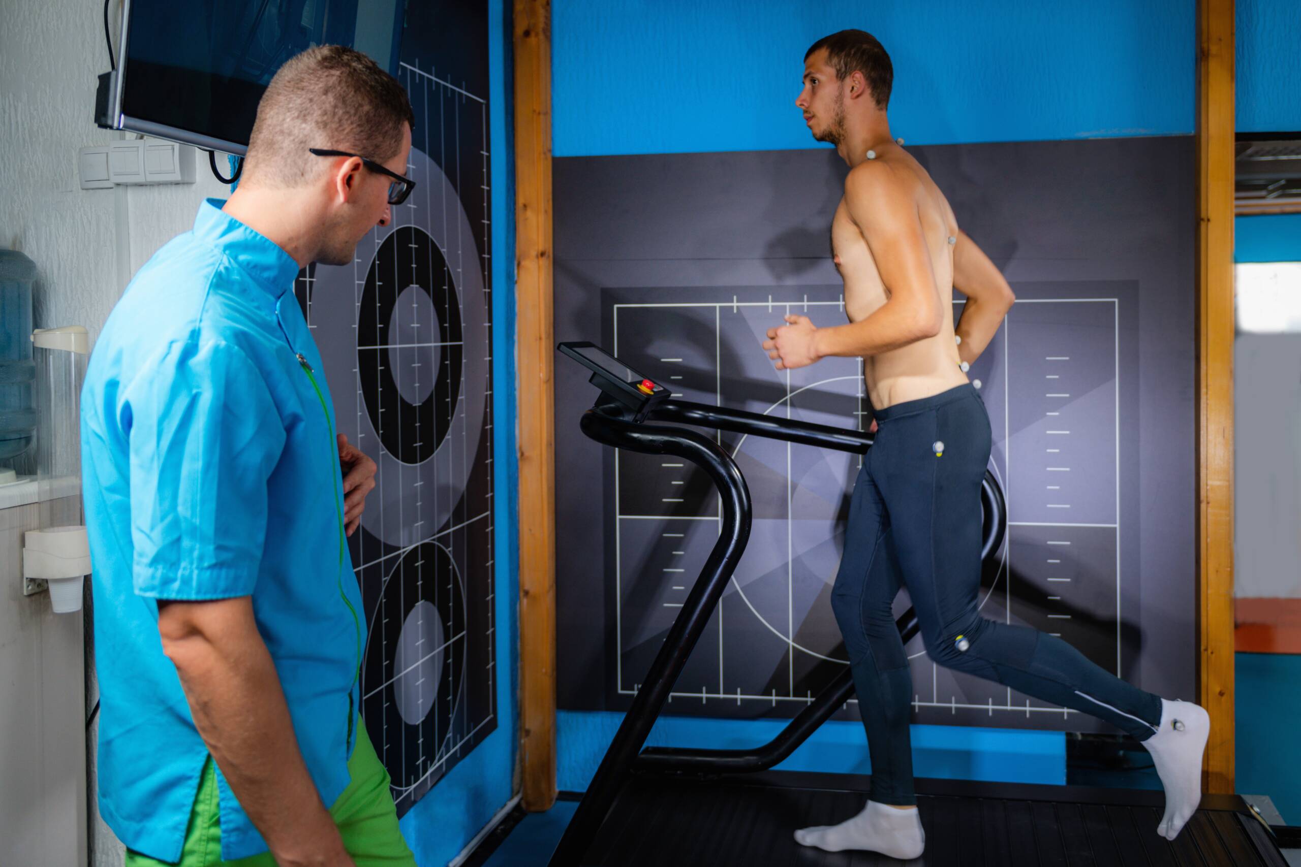 Exercise science researcher monitoring athlete performance on treadmill test
